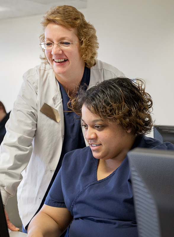 teacher-helping-medical-student-on-computer